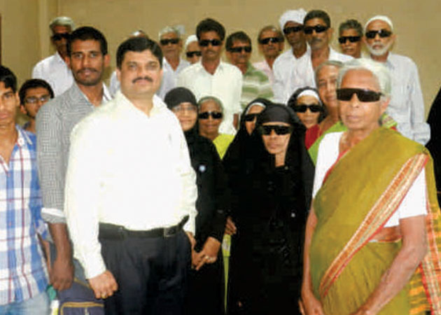 Dr. Krishna Prasad with post-operative patients in a Free Eye Checkup Camp in 2004